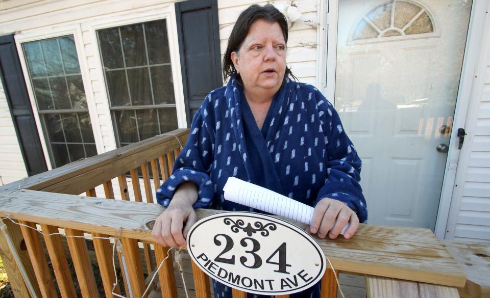 Resident Denise Taylor talks to reporters from the front porch of her home on East Piedmont where two people were shot and killed Thursday evening in Mount Holly.