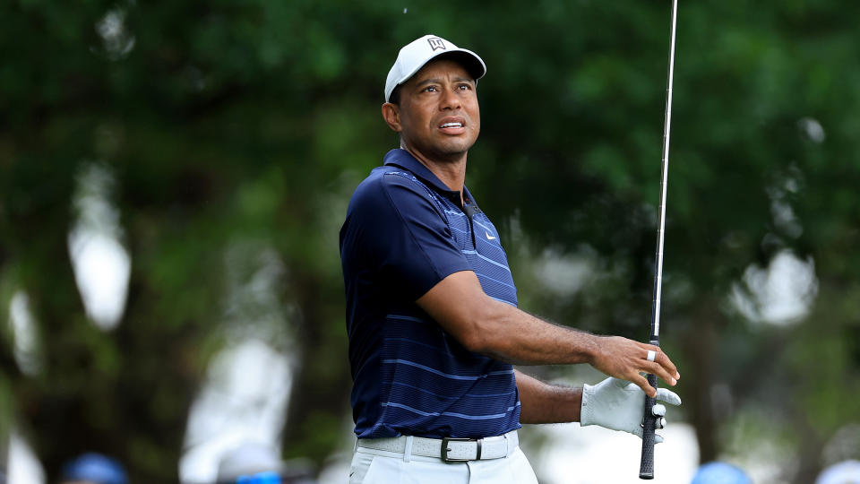   Tiger Woods looks on after hitting an iron shot 