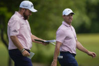 Rory McIlroy, right, of Northern Ireland, and teammate Shane Lowry, of Ireland, walk down the first fairway during the first round of the PGA Zurich Classic golf tournament at TPC Louisiana in Avondale, La., Thursday, April 25, 2024. (AP Photo/Gerald Herbert)