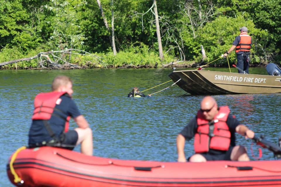 Divers search a cove in Lincoln Woods State Park, where a missing kayaker had last been seen on Saturday afternoon.