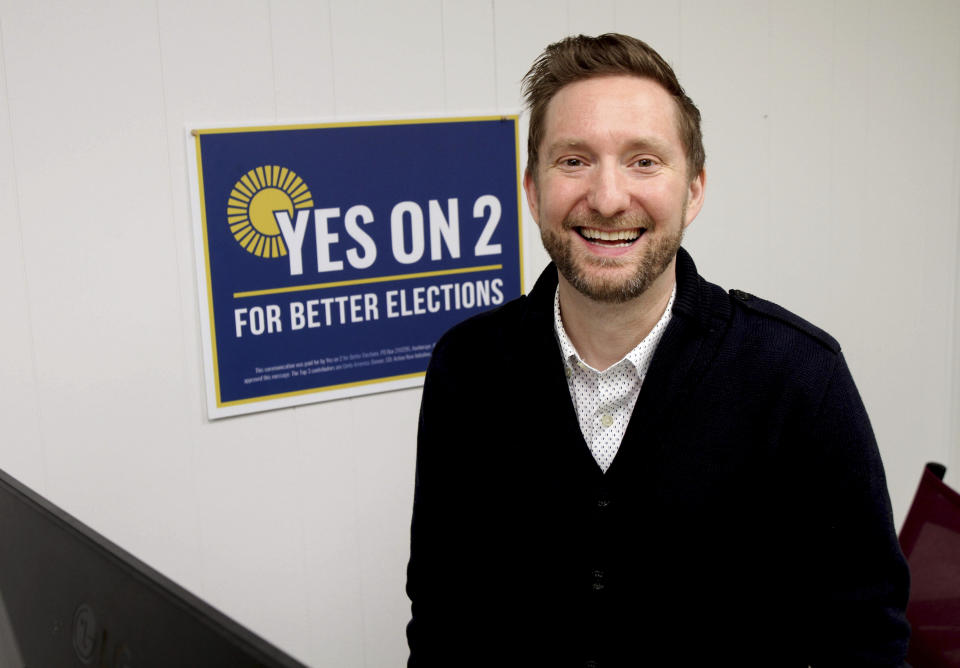 Former Alaska lawmaker Jason Grenn poses for a photo at his office in Anchorage, Alaska, on Friday, Jan. 14, 2022. Grenn was a sponsor of a ballot initiative passed by Alaska voters in 2020 that would end party primaries and send the top four vote-getters, regardless of party affiliation, to the general election, where ranked-choice voting would determine a consensus winner. The model is unique among states and viewed by supporters as a way to encourage civility and cooperation among elected officials. The Alaska Supreme Court is set to hear arguments over the system Tuesday, Jan. 18, 2022. (AP Photo/Mark Thiessen)