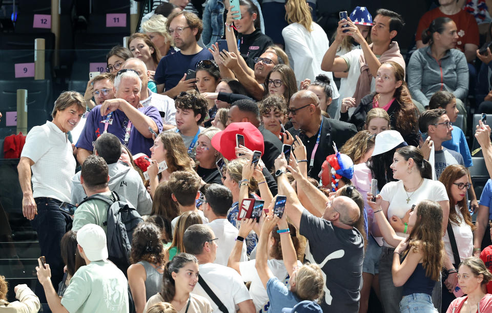 Tom Cruise greets fans ahead of the women's team gymnastics qualifying matches for the 2024 Olympics in Paris, France, on Sunday. (Wally Skalij/Los Angeles Times via Getty Images)