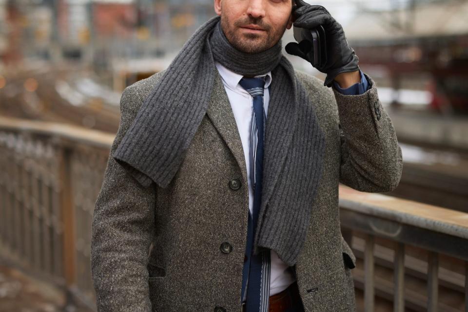 man businessman wearing wool scarf coat gloves on phone