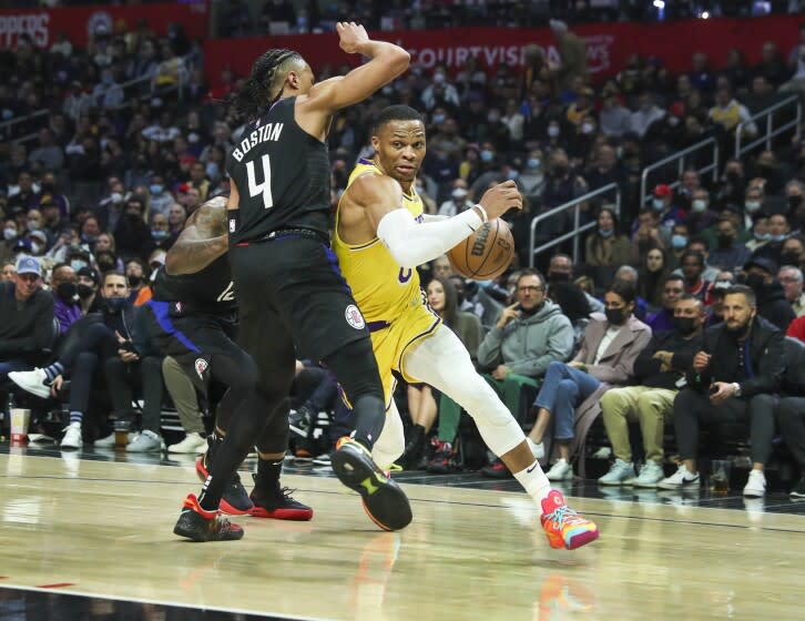 Los Angeles, CA - February 03: Los Angeles Lakers guard Russell Westbrook, right, drives to the hoop around Clippers guard Brandon Boston Jr. in the first half at Crypto.com Arena on Thursday, Feb. 3, 2022 in Los Angeles, CA. (Allen J. Schaben / Los Angeles Times)
