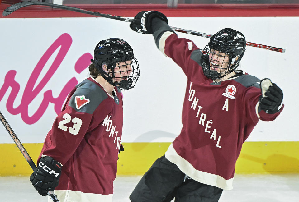 Montreal's Erin Ambrose (23) celebrates with teammate Laura Stacey after scoring against Toronto during the second period of a PWHL hockey game at the Bell Centre in Montreal, Saturday, April 20, 2024.(Graham Hughes/The Canadian Press via AP)