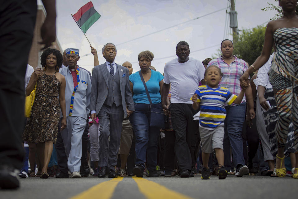 FILE - In this July 19, 2014, file photo, the Rev. Al Sharpton, third from left, and members of the family of Eric Garner, who died after a police chokehold, march toward the site of his death in the Staten Island borough of New York. For more than three decades, Sharpton, 65, has been a fierce advocate for Black American families seeking justice in the wake of violence and countless incidents that highlight systemic racism. (AP Photo/John Minchillo, File)