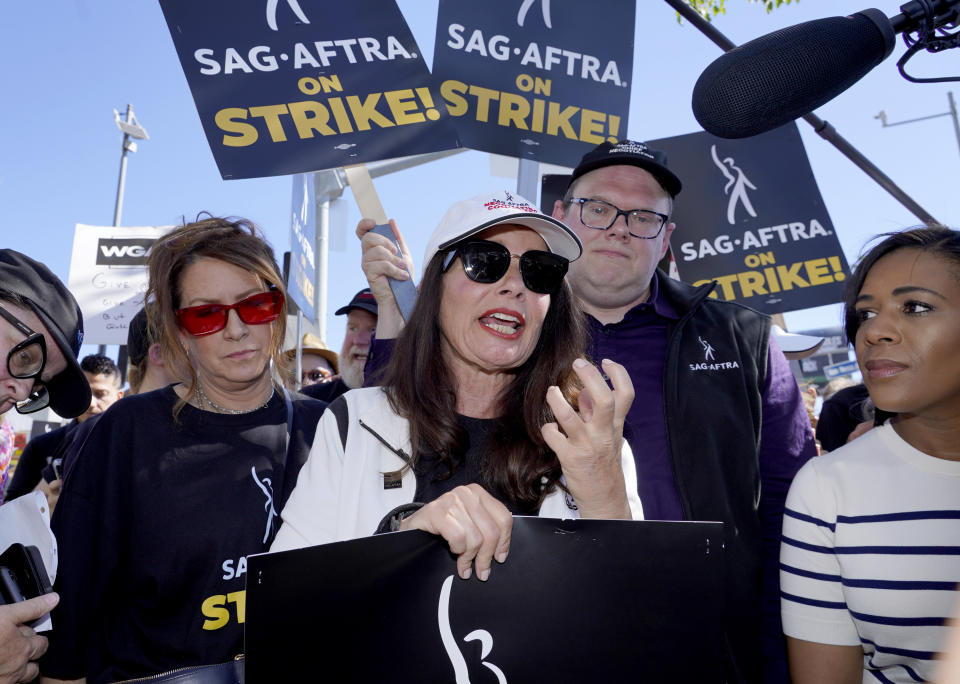 FILE - Actor Joely Fisher, from left, SAG-AFTRA president Fran Drescher and Duncan Crabtree-Ireland, SAG-AFTRA national executive director and chief negotiator, take part in a rally by striking writers and actors outside Netflix studio in Los Angeles on July 14, 2023. (AP Photo/Chris Pizzello, File)