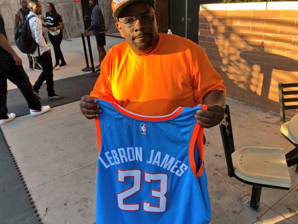 Darrell Bailey holds up his LeBron James Clippers jersey. (Alec Lewis)