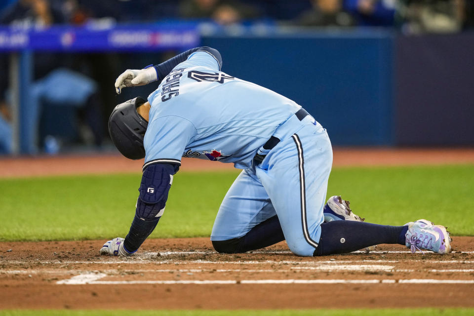 Toronto Blue Jays' George Springer (4) reacts after getting hit by a pitch during the third inning of a baseball game in Toronto on Wednesday, April 26, 2023. (Andrew Lahodynskyj/The Canadian Press via AP)