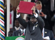 The President of Southern Sudan Salva Kiir waves the newly signed constitution of his country for the crowd to see during a ceremony to celebrate the county’s independence from Sudan on July 9, in the capital Juba. South Sudan is the world’s newest nation and will be the newest member of the United Nations. (Roberto Schmidt/AFP/Getty Images)