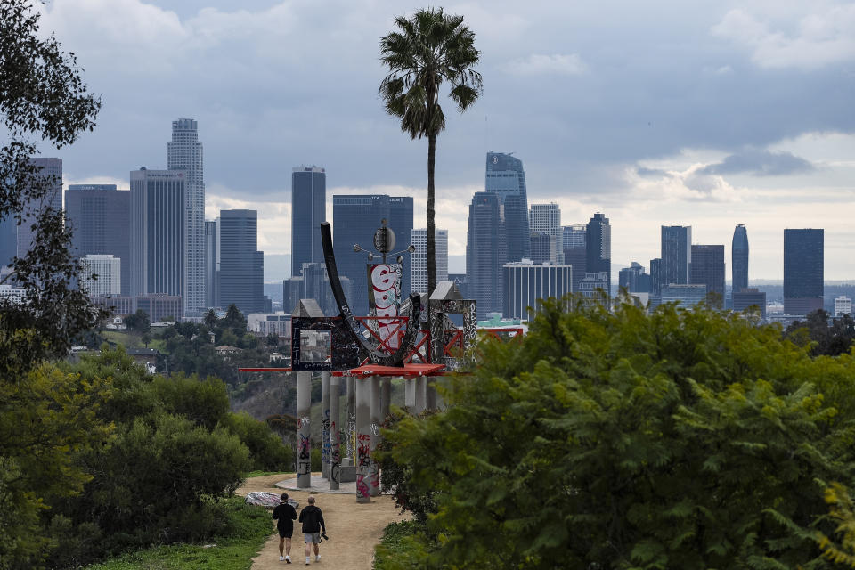 Low clouds gather over the Los Angeles skyline seen from Elysian Park ahead of forecasted rain in Los Angeles on Sunday, Feb. 18, 2024. (AP Photo/Damian Dovarganes)