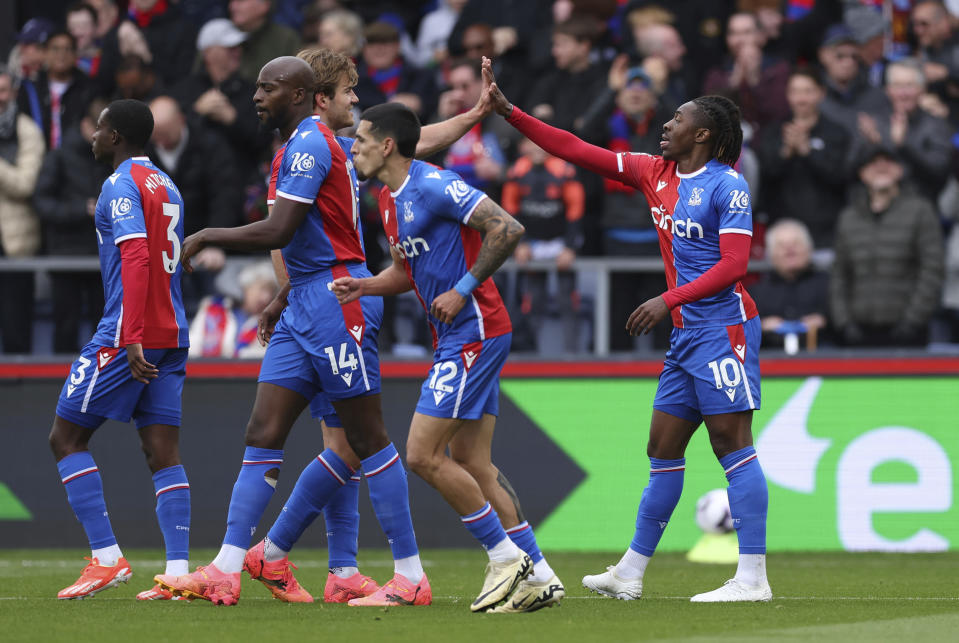 Crystal Palace's Eberechi Eze, right, celebrates scoring their second goal of the game during the English Premier League soccer match between West Ham United and Crystal Palace at Selhurst Park, London, Sunday April 21, 2024. (Steven Paston/PA via AP)