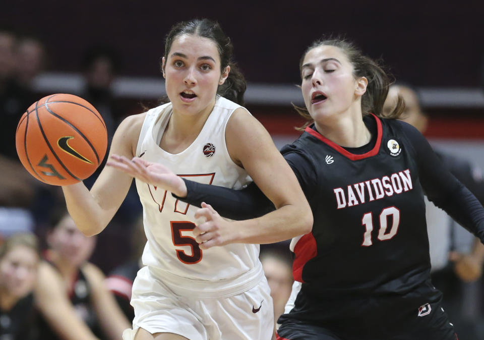 Virginia Tech's Georgia Amoore (5) eludes a steal attempt by Davidson's Sarah Konstans (10) during the second half of an NCAA college basketball game in Blacksburg Va. Tuesday Nov. 9 2021. (Matt Gentry/The Roanoke Times via AP)