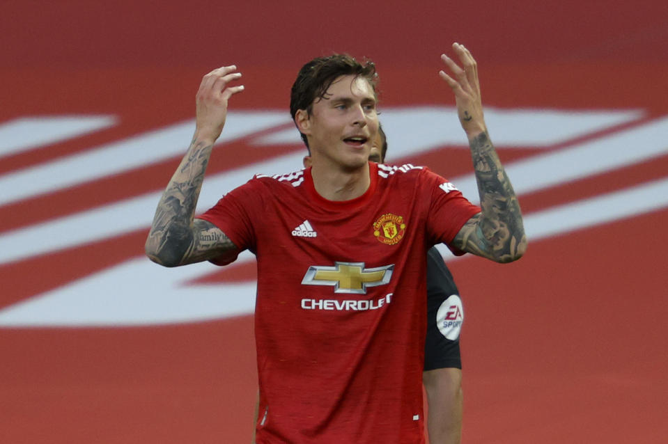 Manchester United's Victor Lindelof reacts after a penalty is awarded to Crystal Palace upon VAR review during the English Premier League soccer match between Manchester United and Crystal Palace at the Old Trafford stadium in Manchester, England, Saturday, Sept. 19, 2020. (Richard Heathcote/Pool via AP)