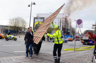 Former Danish Minister of Culture and current CEO of Danish Business, Brian Mikkelsen, left, assists with the evacuation of paintings from the Boersen burning in Copenhagen on Tuesday, April 16, 2024. A fire raged through one of Copenhagen’s oldest buildings on Tuesday, causing the collapse of the iconic spire of the 17th-century Old Stock Exchange as passersby rushed to help emergency services save priceless paintings and other valuables. (Ida Marie Odgaard/Ritzau Scanpix via AP)