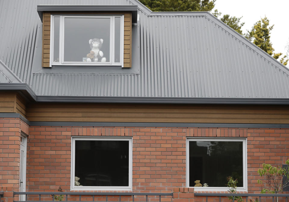 In this Sunday, March 29, 2020, photo, teddy bears sit in windows of a house in Christchurch, New Zealand. New Zealanders are embracing an international movement in which people are placing teddy bears in their windows during coronavirus lockdowns to brighten the mood and give children a game to play by spotting the bears in their neighborhoods. (AP Photo/Mark Baker)