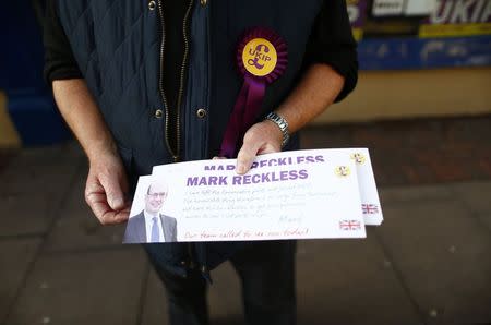 A party activist holds leaflets for Mark Reckless, the former Conservative local MP now standing for United Kingdom Independence Party (UKIP) in the by-election, in Rochester, in southeastern England, November 11, 2014. REUTERS/Andrew Winning