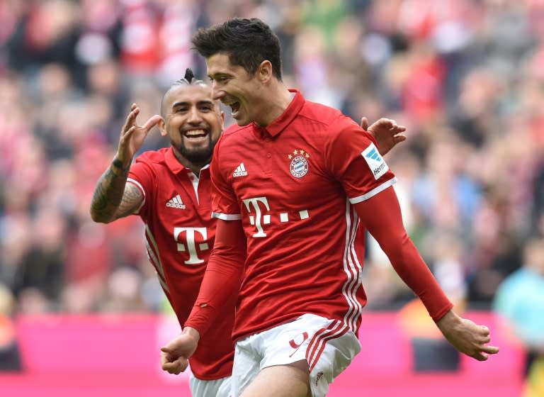 Bayern Munich's striker Robert Lewandowski (R) and Bayern Munich's midfielder Arturo Vidal (L) celebrate after the third goal for Munich during the German First division Bundesliga football match Bayern Munich vs Eintracht Frankfurton March 11, 2017