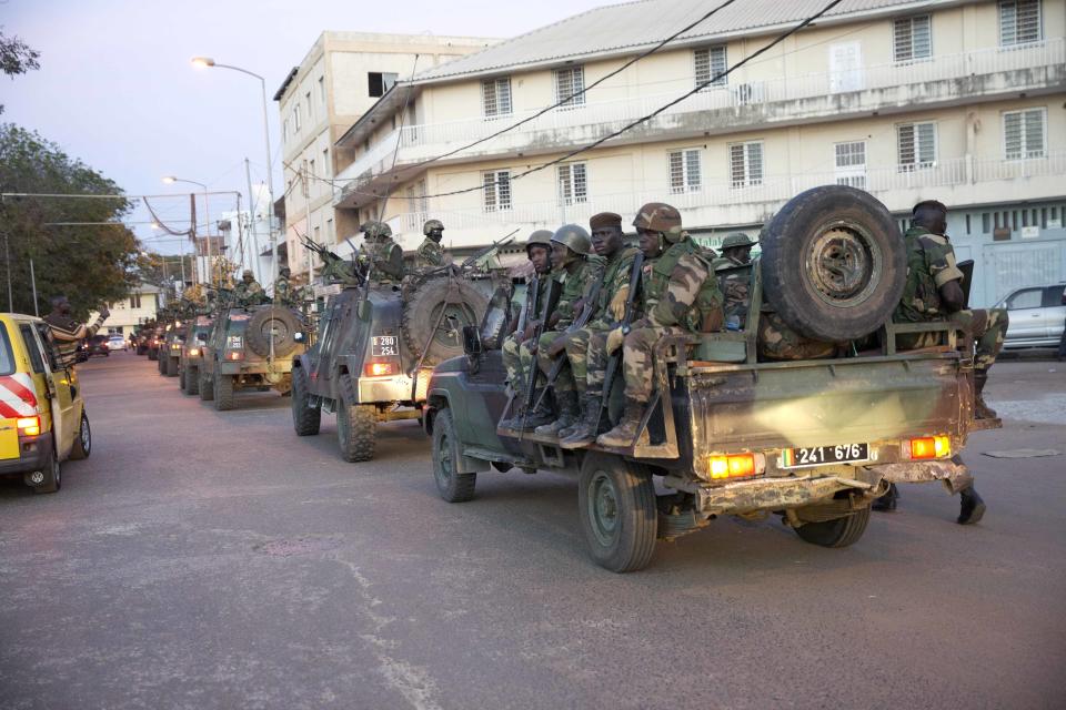 FILE - ECOWAS Senegalese troops take position near the state house in the Gambian capital Banjul Jan. 22, 2017. West Africa's regional bloc known as ECOWAS has threatened the use of force in reinstating the president of Niger after he was deposed by his military but how the bloc would carry out the threat remains unclear, with a military deployment on the table. (AP Photo/Jerome Delay, File)