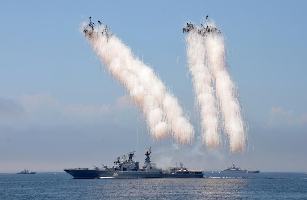 Russian warships sail past exploding anti-missile ordnance during a rehearsal for the Navy Day parade in 2016: Reuters