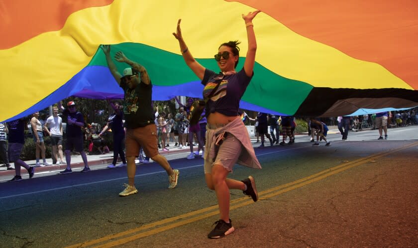 Volunteers keep the pride flag aloft during the West Hollywood Pride parade on Sunday, June 5, 2022 in West Hollywood, CA.
