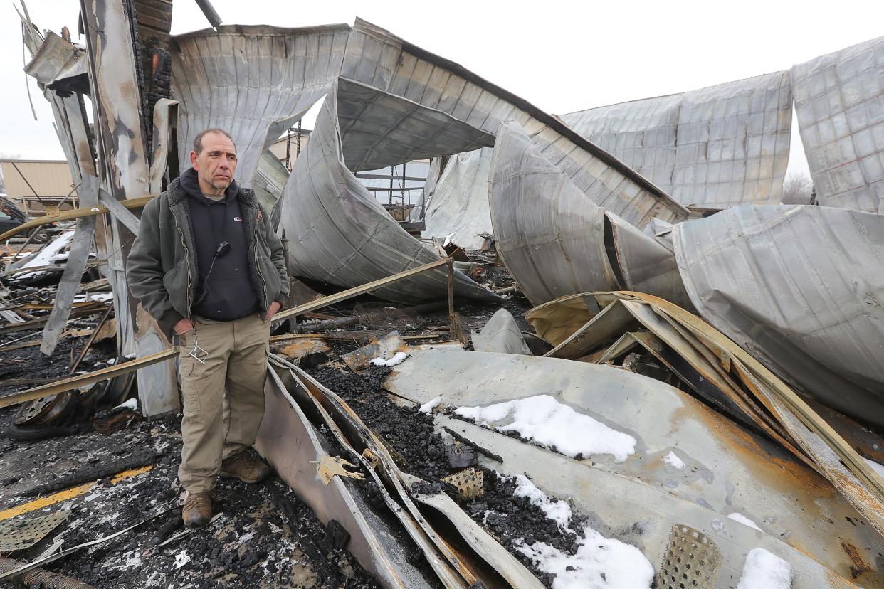 Paul Baker, Kamper City operations manager, surveys what is left after a Dec. 17 fire destroyed a three-year-old service building in Peninsula. Demolition started Friday at the site.