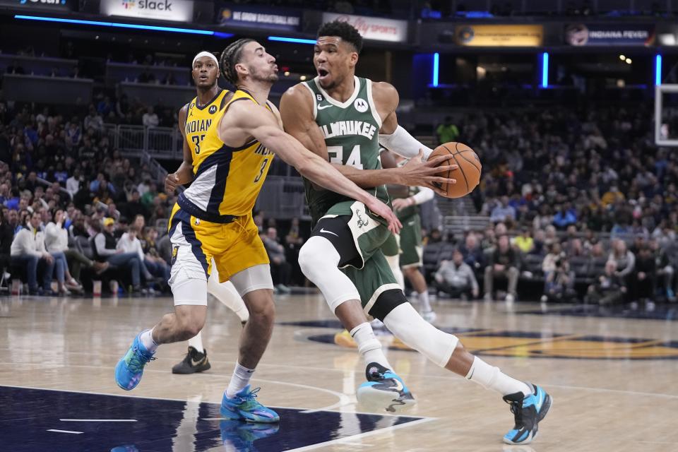 Milwaukee Bucks' Giannis Antetokounmpo (34) goes to the basket against Indiana Pacers' Chris Duarte (3) during the second half of an NBA basketball game, Friday, Jan. 27, 2023, in Indianapolis. (AP Photo/Darron Cummings)