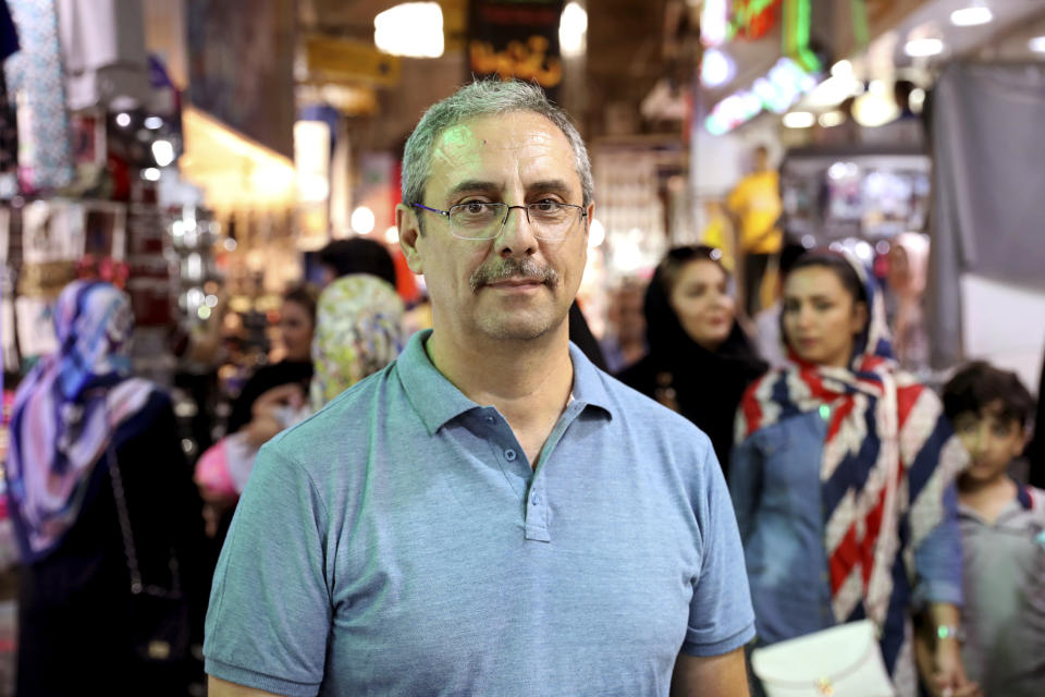 Yussuf, a 52-year-old retired banking official, is interviewed by The Associated Press at the old main bazaar in Tehran, Iran, Tuesday, July 2, 2019. While opinions differ across Tehran's Grand Bazaar about the ongoing tensions between the U.S. and Iran over its unraveling nuclear deal, there's one thing those in the beating heart of Iran's capital city agree on: American sanctions hurt the average person, not those in charge. (AP Photo/Ebrahim Noroozi)
