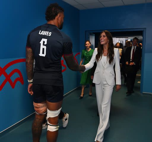 <p>Dan Mullan/Getty Images</p> Kate Middleton meets England Rugby team players in their dressing rooms after their Rugby World Cup match win