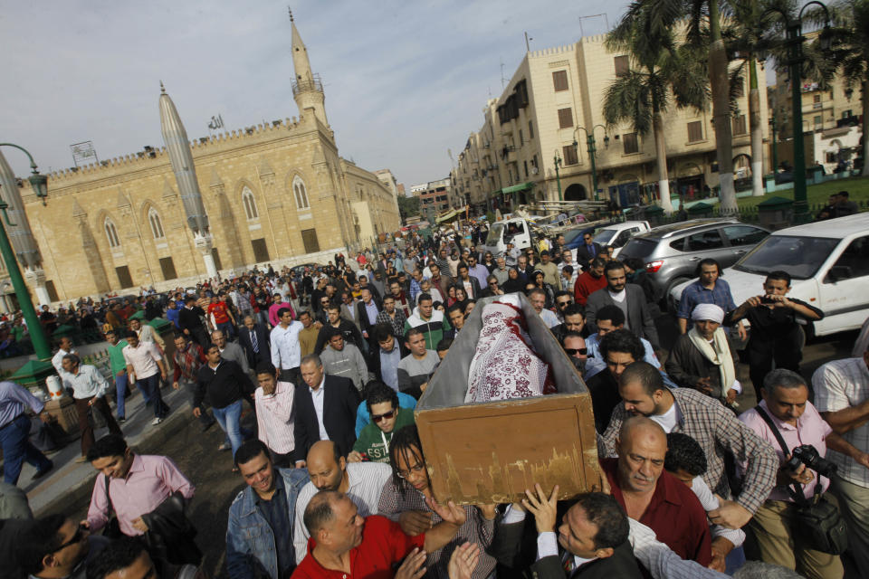 Egyptians carry the coffin of Egypt’s best known satirical poet, Ahmed Fouad Negm, 84, following funeral prayers at al-Hussein mosque in Cairo, Egypt, Tuesday, Dec. 3, 2013. Known as the "poet of the people," Negm's use of colloquial Egyptian Arabic endeared him to his countrymen who saw in his verse an unvarnished reflection of how they felt about milestones in their nation's history like the humiliating defeat at the hands of Israel in 1967, the 1979 peace treaty with Israel and the authoritarian rule of Hosni Mubarak. (AP Photo/Amr Nabil)