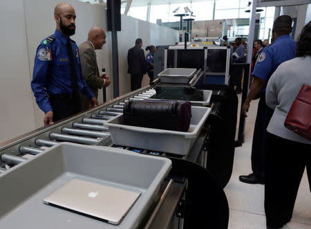 FILE PHOTO: Baggage and a laptop are scanned using the Transport Security Administration's new Automated Screening Lane technology at Terminal 4 of JFK airport in New York City, U.S., May 17, 2017. REUTERS/Joe Penney/File Photo