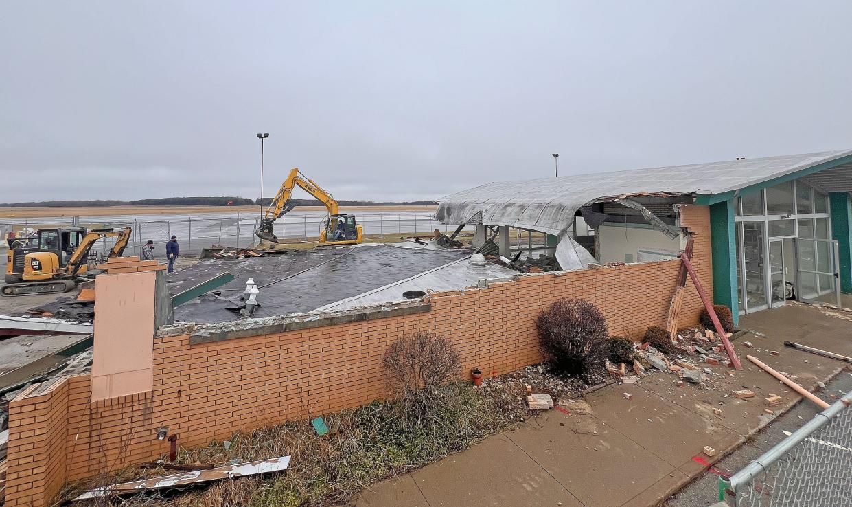 The roof of the former Subway at the Mansfield Lahm Airport is demolished Thursday morning.