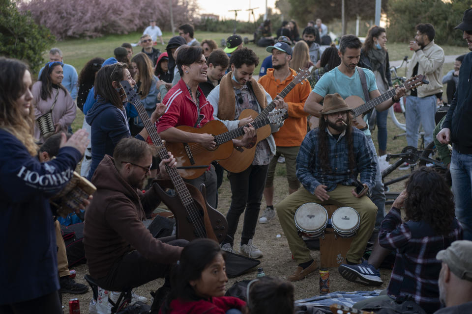 Local people play their instruments as they gather at a public park in Barcelona, Spain, Sunday, March 28, 2021. (AP Photo/Emilio Morenatti)