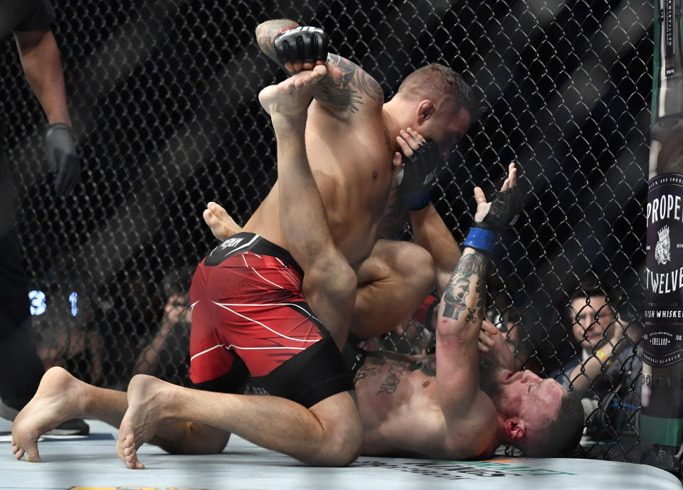 LAS VEGAS, NEVADA - JULY 10: (L-R) Dustin Poirier punches Conor McGregor of Ireland in their welterweight fight during the UFC 264 event at T-Mobile Arena on July 10, 2021 in Las Vegas, Nevada. (Photo by Chris Unger/Zuffa LLC)
