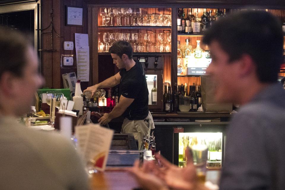 A bartender works at BBC Tavern and Grill in Greenville.