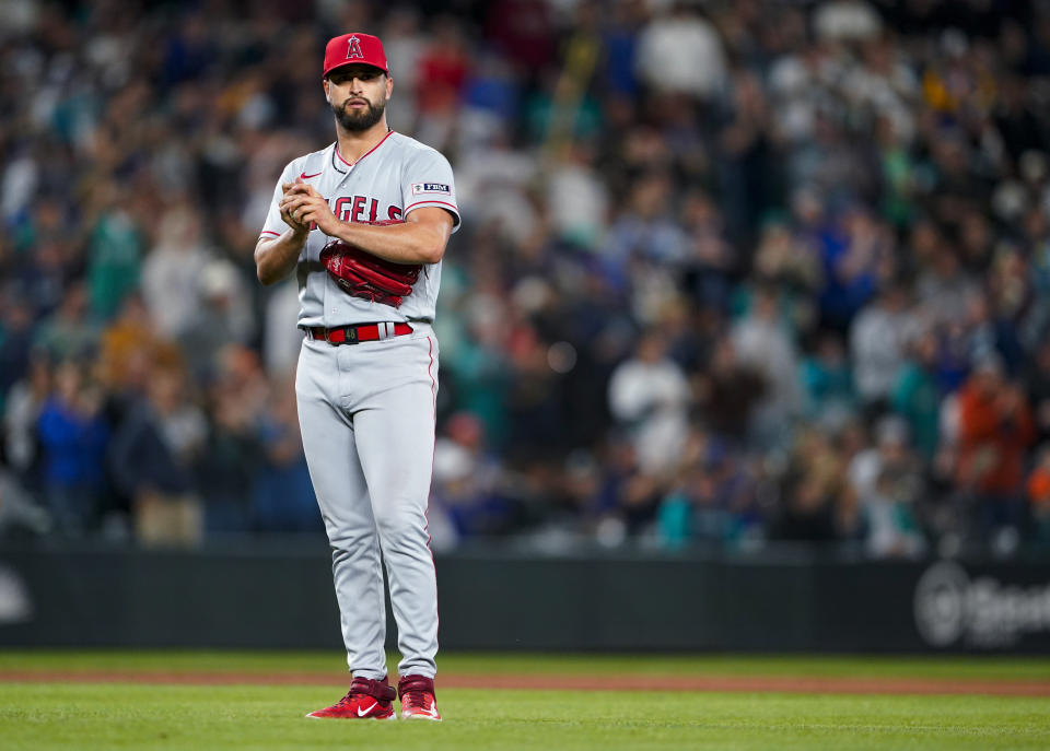 Los Angeles Angels starting pitcher Patrick Sandoval rubs up a new ball after giving up a home run to Seattle Mariners' Eugenio Suarez during the fifth inning of a baseball game Tuesday, Sept. 12, 2023, in Seattle. (AP Photo/Lindsey Wasson)