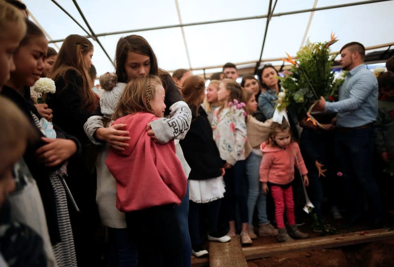 Relatives react during the funeral of Miller and her children who were killed by unknown assailants in LeBaron