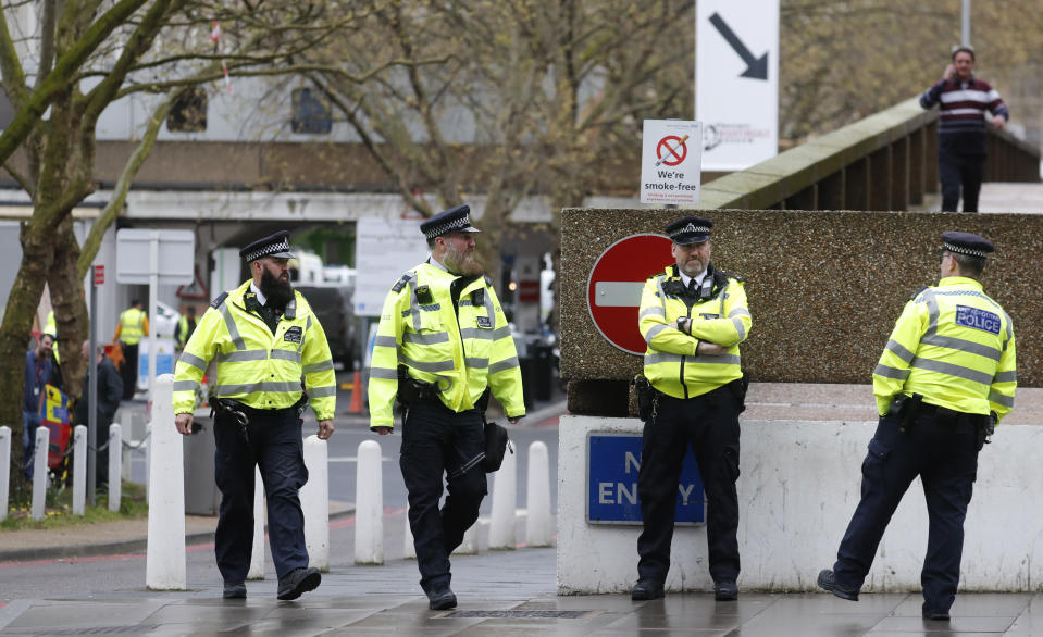 Police officers stand guard outside a hospital where it is believed that Britain's Prime Minister Boris Johnson is undergoing tests after suffering from coronavirus symptoms, in London, Monday, April 6, 2020. British Prime Minister Boris Johnson has been admitted to a hospital with the coronavirus. Johnson's office says he is being admitted for tests because he still has symptoms 10 days after testing positive for the virus. (AP Photo/Frank Augstein)
