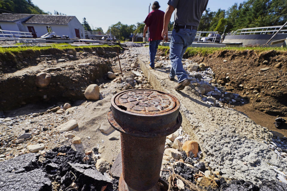 A sewer pipe is exposed due to eroded land at the wastewater treatment plant following July flooding, Wednesday, Aug. 2, 2023, in Ludlow, Vt. Across the U.S., municipal water systems and sewage treatment plants are at increasing risk of damage from floods and sea-level rise brought on in part or even wholly by climate change. The storm that walloped Ludlow especially hard, damaging the picturesque ski town’s system for cleaning up sewage before it’s discharged into the Williams River. (AP Photo/Charles Krupa)