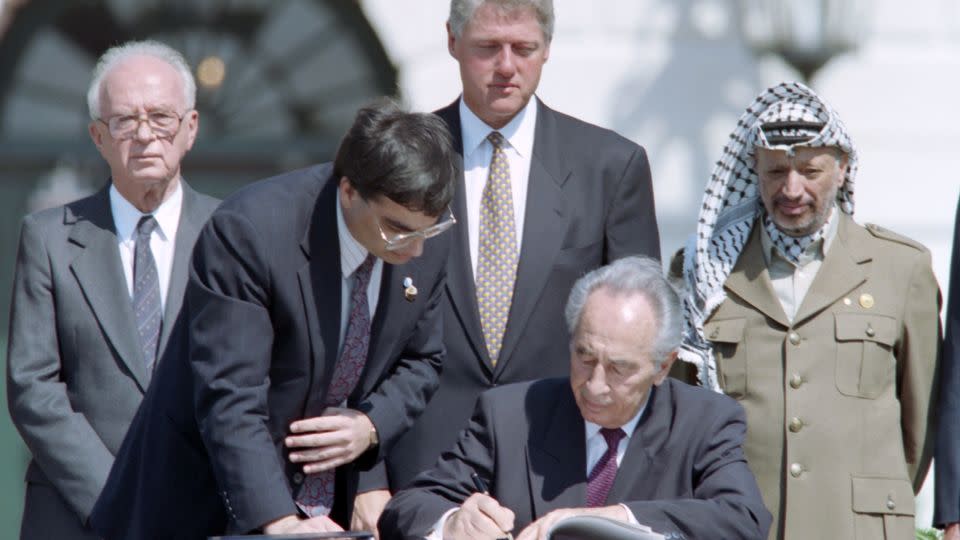 A brief period of serious negotiations: Then-Israeli Foreign Minister Shimon Peres signs the Oslo Accords at the White House as Israeli Prime Minister Yitzhak Rabin, President Bill Clinton and PLO Chairman Yasser Arafat look on, September 1993. - J. DAVID AKE/AFP/AFP/Getty Images