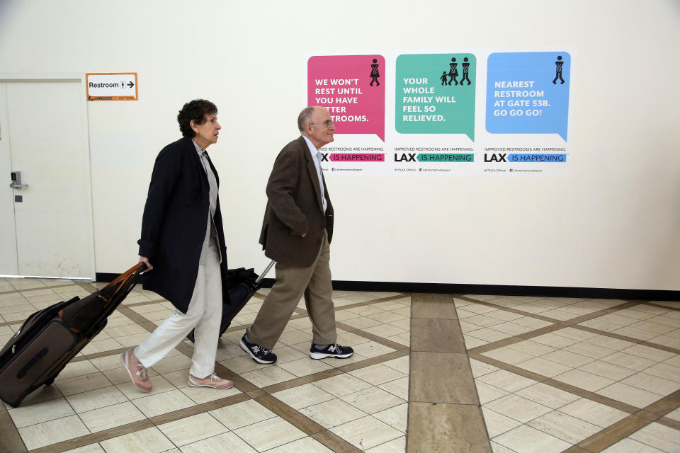 In this Monday, May 5, 2014 photo passengers walk at the Delta Airlines terminal, under renovation at Los Angeles International Airport (LAX). The aging airport is scheduled to get newly surfaced roads, upgraded restaurants with Los Angeles themes, and some terminal makeovers that will infuse more sunlight into otherwise cave-like interiors. Also in the plans are new bathrooms and, that essential for travelers, more outlets and USB ports for charging electronic devices. (AP Photo/Nick Ut )