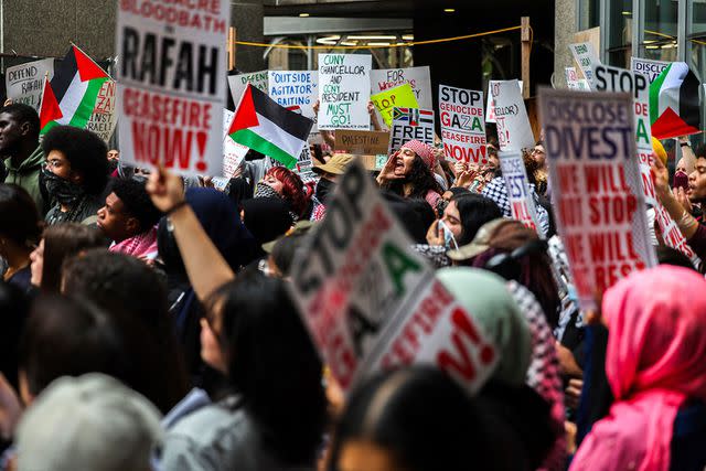 <p>CHARLY TRIBALLEAU/AFP via Getty</p> Protestors outside the Met Gala