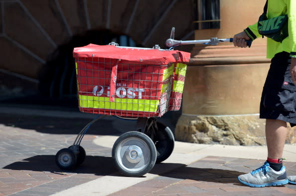 A postman from Australia Post makes postal deliveries in Sydney's central business district.