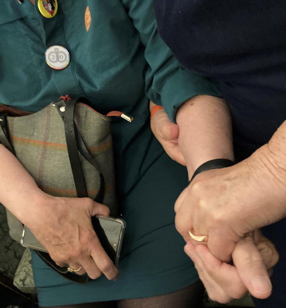 Lucie Bauer and Annie Kiermaier of Maine hold hands at the ceremony marking the 20th anniversary of legal same-sex marriage in Massachusetts.