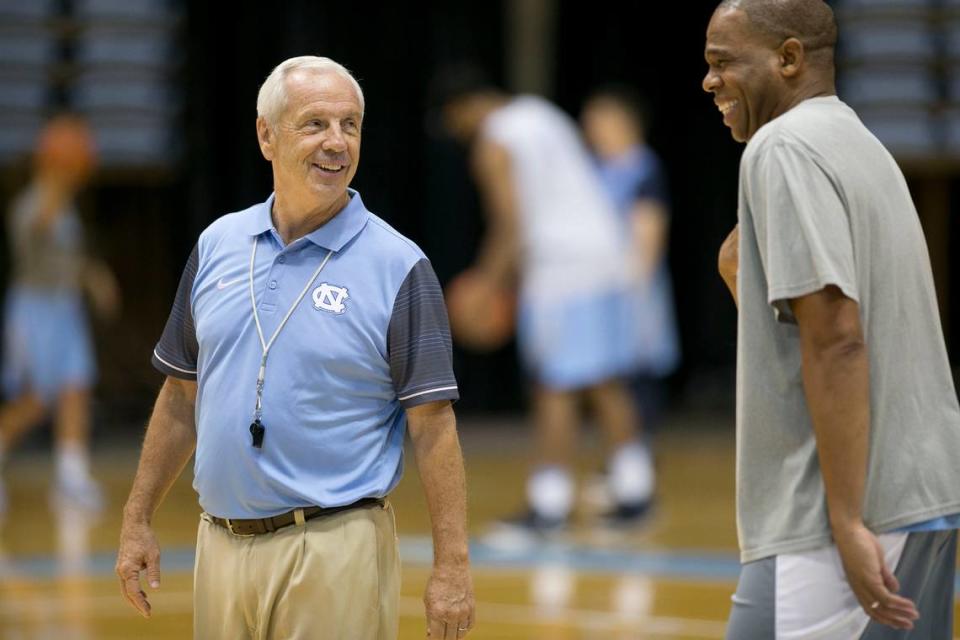 North Carolina head coach Roy Williams laughs with assistant coach Hubert Davis during practice on Tuesday, October 11, 2016 at the Smith Center in Chapel Hill, N.C.