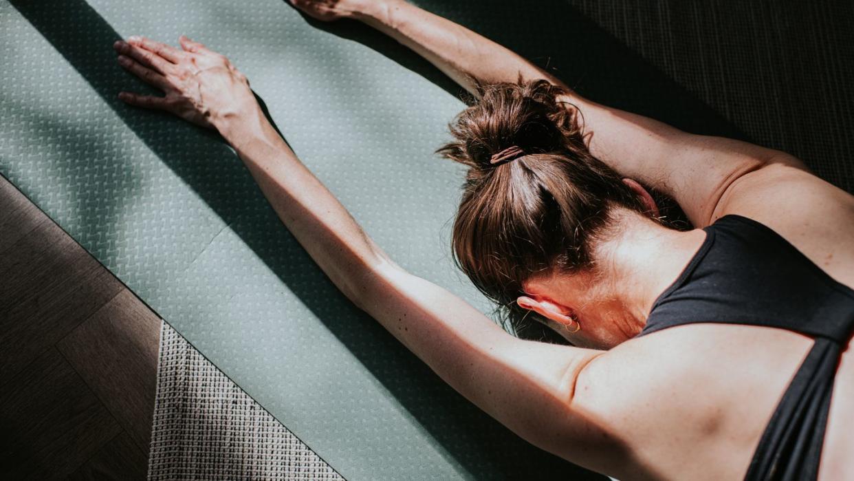 close up image of a woman in child's pose position