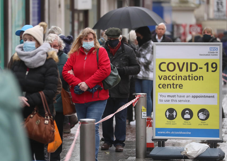 People queue in bad weather to enter a COVID-19 vaccination centre in Folkestone, Kent, during England's third national lockdown to curb the spread of coronavirus. Picture date: Friday January 29, 2021. (Photo by Gareth Fuller/PA Images via Getty Images)
