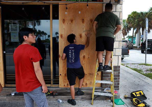 CLEARWATER BEACH, FLORIDA - AUGUST 29: Workers place protective plywood over the openings at Toucan's Bar & Grill before the possible arrival of Hurricane Idalia on August 29, 2023 in Clearwater Beach, Florida. Hurricane Idalia is forecast to make landfall on the Gulf Coast of Florida Wednesday morning. (Photo by Joe Raedle/Getty Images)