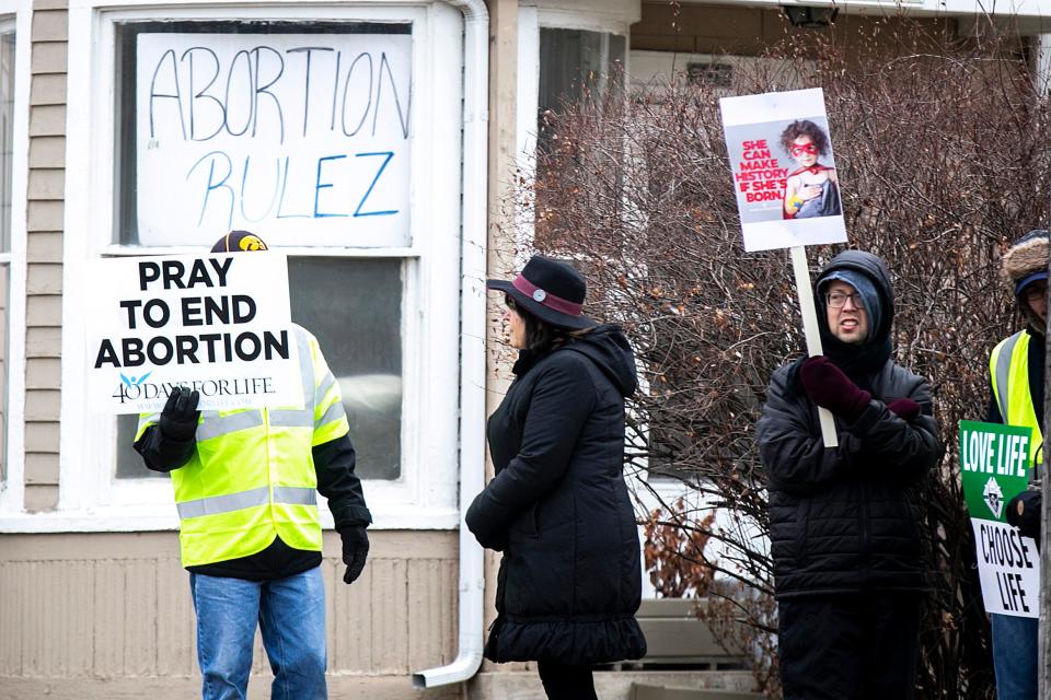 Anti-abortion activists hold signs during a March for Life rally, Saturday, Jan. 21, 2023, in Iowa City, Iowa.