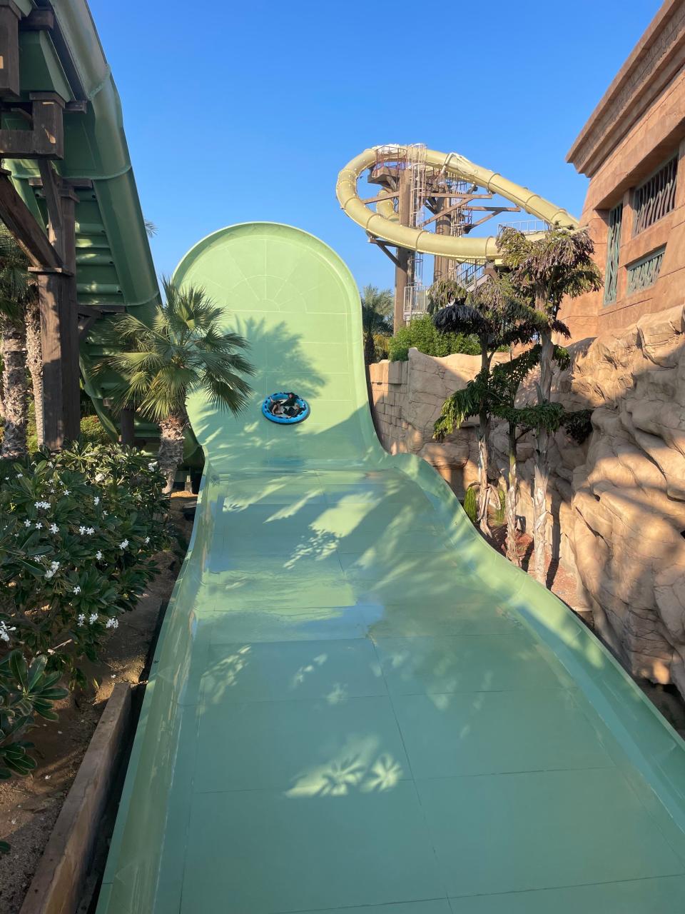 A group rides a round tube down a water slide